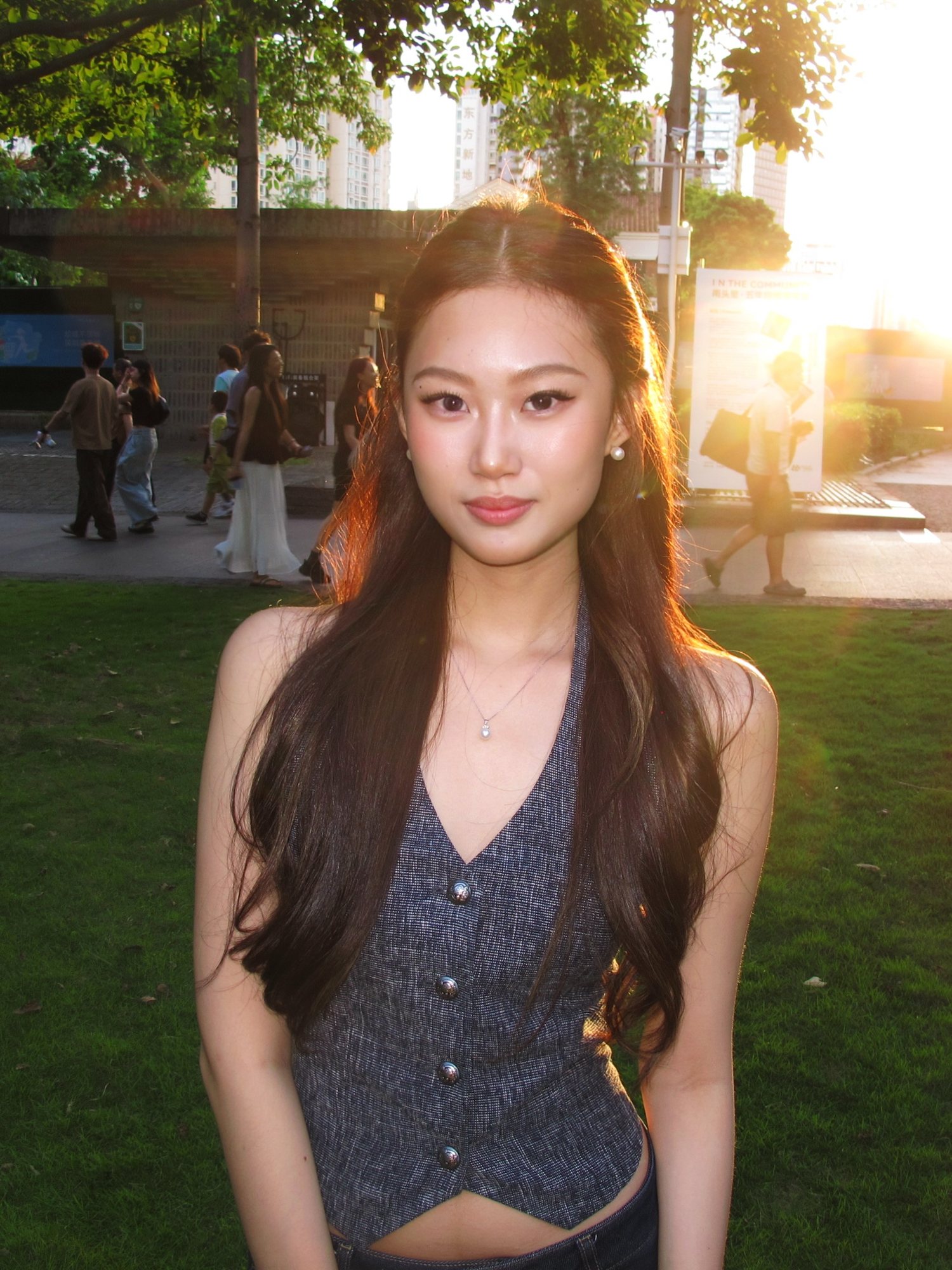 Angelina standing on the campus walkway in late afternoon light