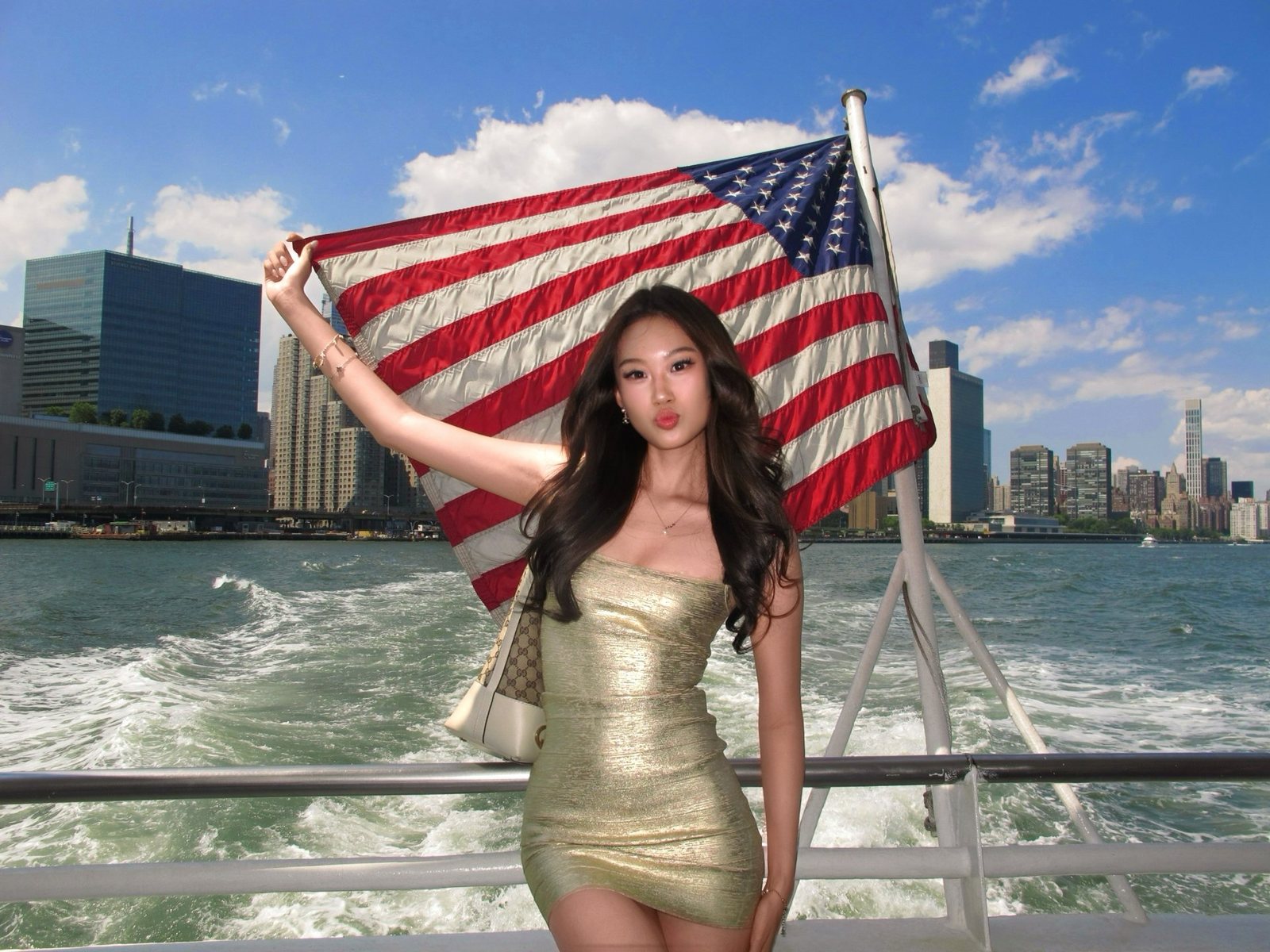 Holding an American flag on the back of a boat crossing the harbour