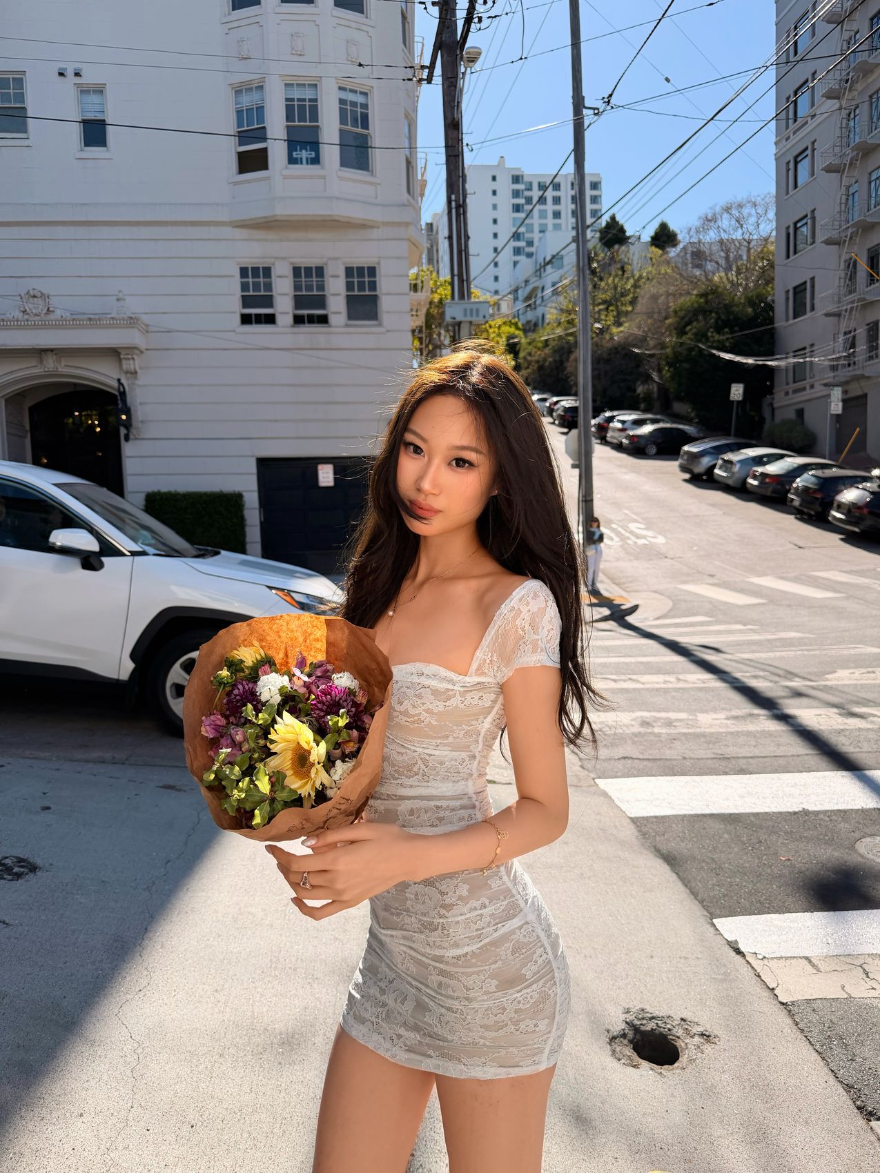 Angelina holding flowers on a residential street, editorial series