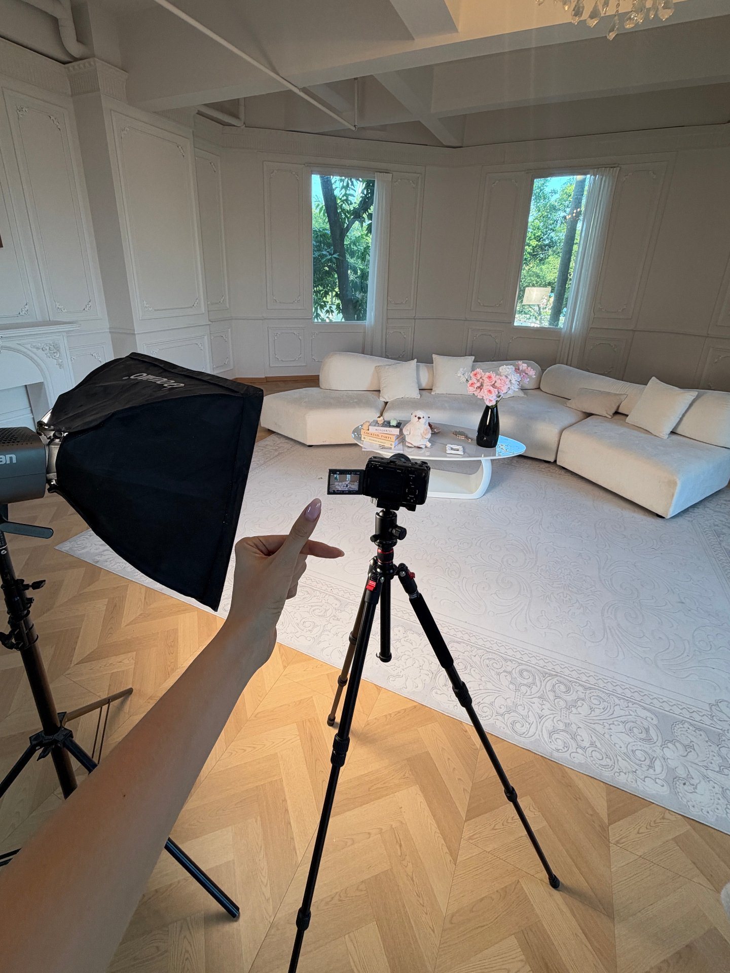 Setting up a shoot: softbox, camera on a tripod, and a styled room behind