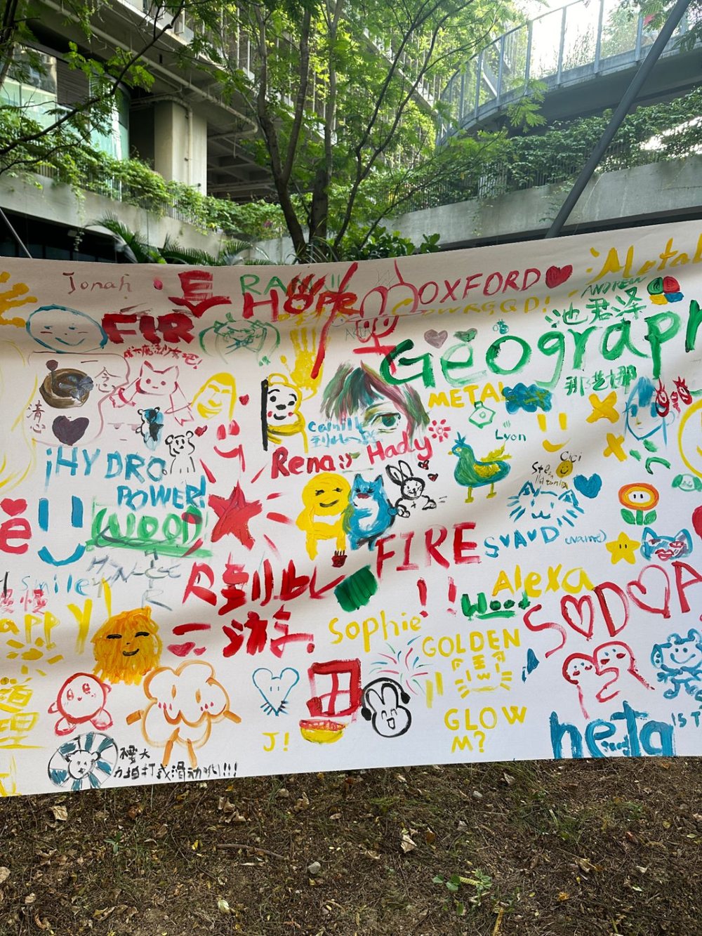 A wall of painted messages and club names made by students